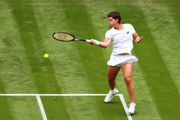 Carla Suarez Navarro of Spain plays a forehand in her Ladies' Singles First Round match against Ashleigh Barty of Australia during Day Two of The...
