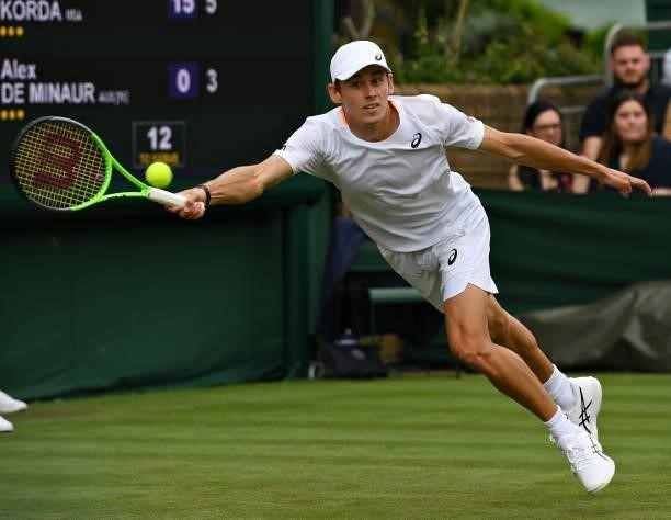 Alex de Minaur of Australia stretches to play a forehand in his Men's Singles First Round match against Sebastian Korda of United States during Day...