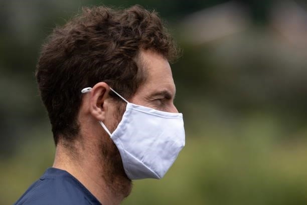 Andy Murray of Great Britain wears a face mask as he looks on from the Aorangi Practice Courts during Day Two of The Championships - Wimbledon 2021...