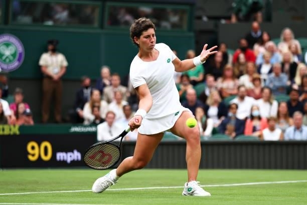 Carla Suarez Navarro of Spain plays a forehand in her Ladies' Singles First Round match against Ashleigh Barty of Australia during Day Two of The...