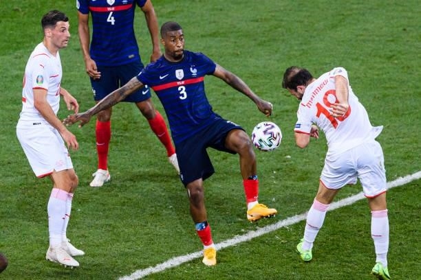 Presnel Kimpembe of France fights for the ball with Admir Mehmedi of Switzerland during the UEFA Euro 2020 Championship Round of 16 match between...