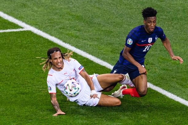 Kevin Mbabu of Switzerland battles for the ball with Kingsley Coman of France during the UEFA Euro 2020 Championship Round of 16 match between France...