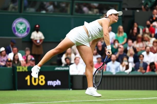 Ashleigh Barty of Australia serves in her Ladies' Singles First Round match against Carla Suarez Navarro of Spain during Day Two of The Championships...
