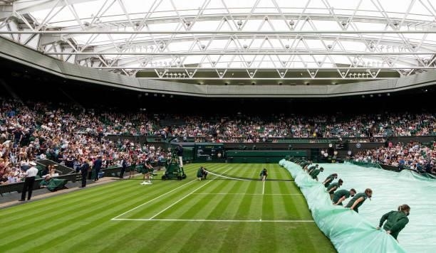 General view of Centre Court as the covers are removed in the Ladies' Singles First Round match between Ashleigh Barty of Australia and Carla Suarez...