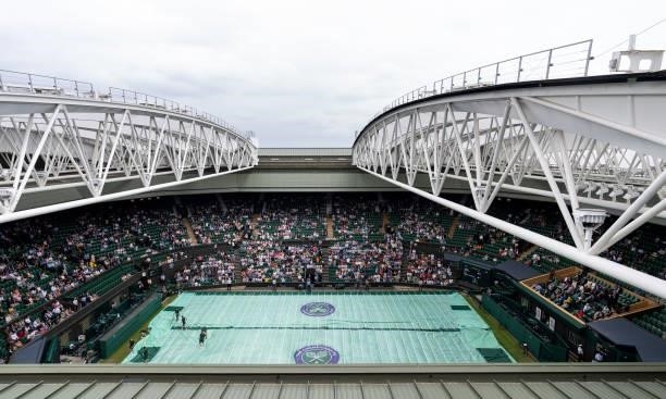 General view of Centre Court as the covers are brought on in the Ladies' Singles First Round match between Ashleigh Barty of Australia and Carla...