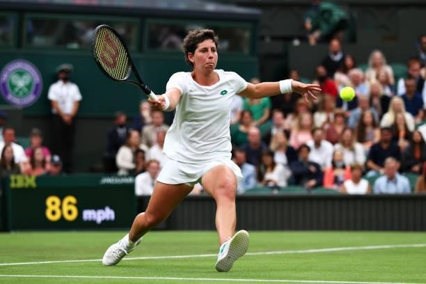 Carla Suarez Navarro of Spain stretches to play a forehand in her Ladies' Singles First Round match against Ashleigh Barty of Australia during Day...