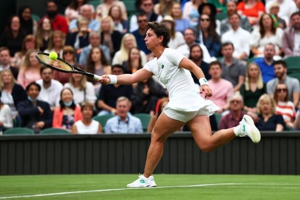 Carla Suarez Navarro of Spain stretches to play a forehand in her Ladies' Singles First Round match against Ashleigh Barty of Australia during Day...