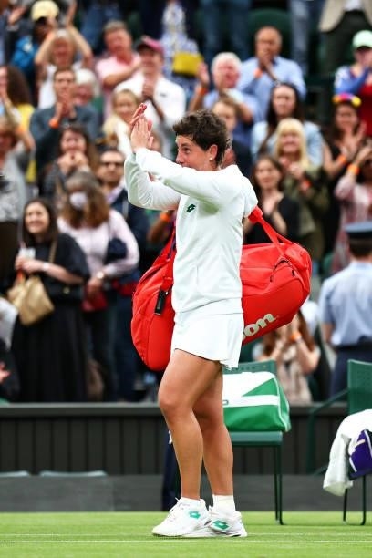 Carla Suarez Navarro of Spain applauds the fans as she walks off the court after loosing her Ladies' Singles First Round match against Ashleigh Barty...