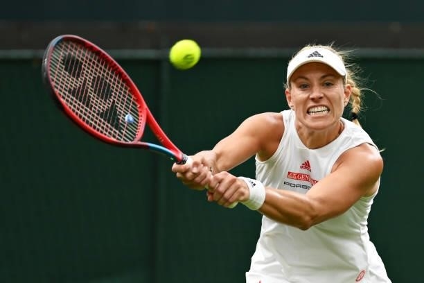 Angelique Kerber of Germany plays a backhand in her Ladies' Singles First Round match against Nina Stojanovic of Serbia during Day Two of The...