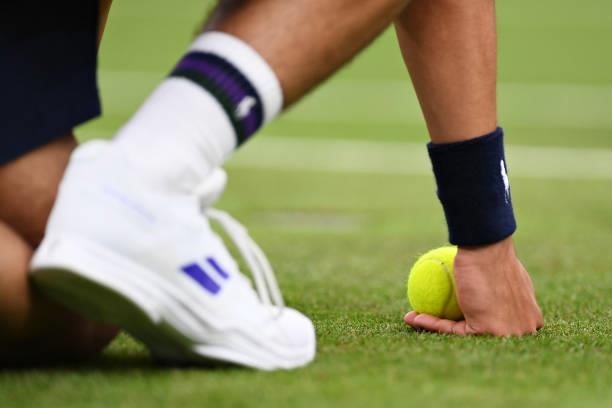 Detailed view as a ball kid holds a ball at the side of the court during Day Two of The Championships - Wimbledon 2021 at All England Lawn Tennis and...