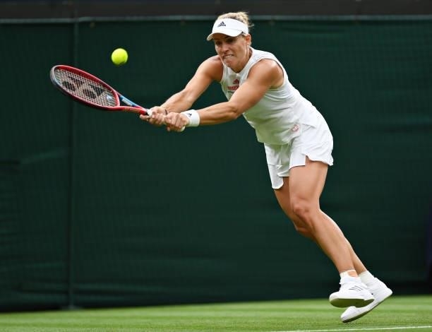 Angelique Kerber of Germany stretches to play a backhand in her Ladies' Singles First Round match against Nina Stojanovic of Serbia during Day Two of...