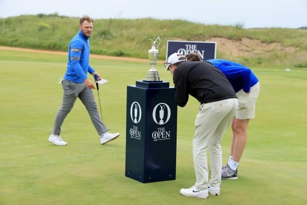 Sam Forgan of England walks past the Claret Jug before his first round during Final Qualifying for the 149th Open at Prince's Golf Club on June 29,...