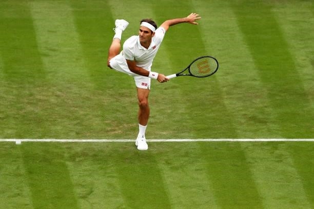 Roger Federer of Switzerland serves in his Men's Singles First Round match against Adrian Mannarino of France during Day Two of The Championships -...