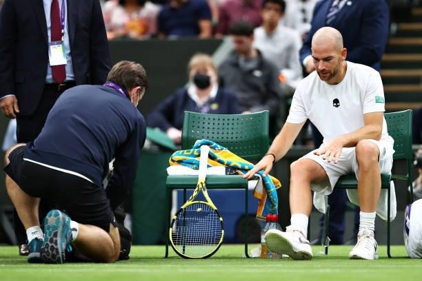 Adrian Mannarino of France takes a seat as he prepares to receive medical treatment in his Men's Singles First Round match against Roger Federer of...