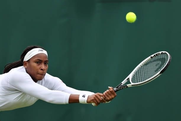 Coco Gauff of The United States stretches to play a backhand in her Ladies' Singles First Round match against Francesca Jones of Great Britain during...