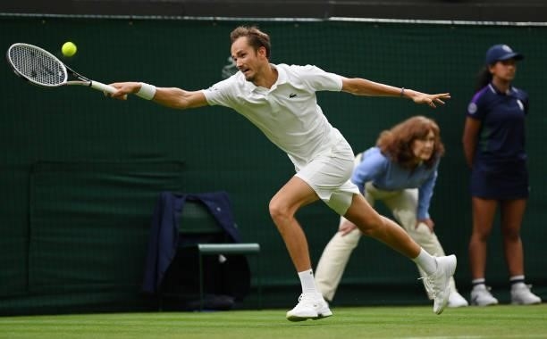 Daniil Medvedev of Russia stretches to play a forehand in his Men's Singles First Round match against Jan-Lennard Struff of Germany during Day Two of...
