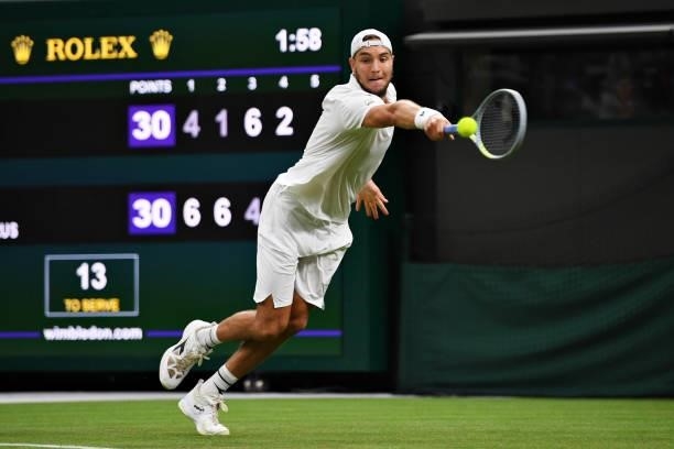 Jan-Lennard Struff of Germany stretches to play a backhand in his Men's Singles First Round match against Daniil Medvedev of Russia during Day Two of...