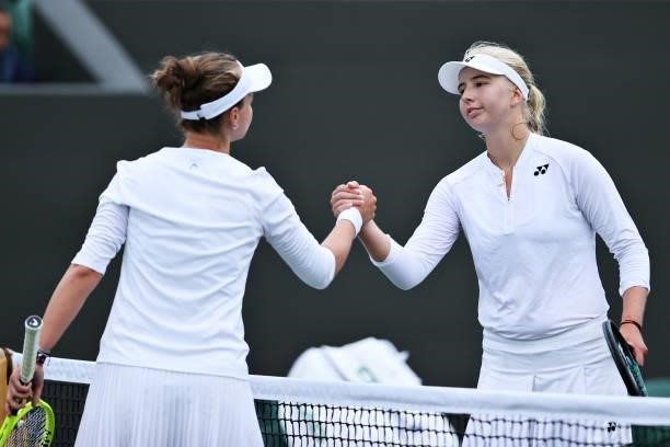 Clara Tauson of Denmark and Barbora Krejcikova of The Czech Republic shake hands at the net after their Ladies' Singles First Round match during Day...