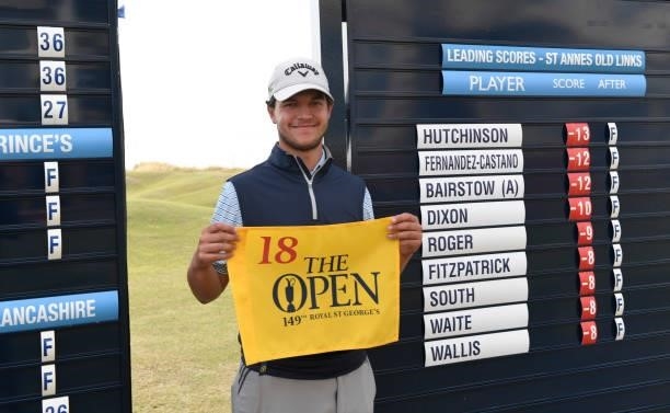Sam Bairstow of England poses with The Open flag after qualifying for the 149th Open Championship during Final Qualifying for the 149th Open at St...