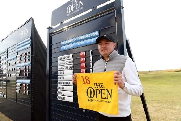 Ben Hutchinson of England poses with The Open flag after qualifying for the 149th Open Championship during Final Qualifying for the 149th Open at St...