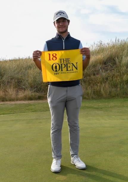 Sam Bairstow of England poses with The Open flag after qualifying for the 149th Open Championship during Final Qualifying for the 149th Open at St...