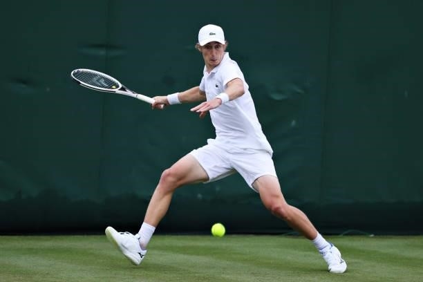 Marc Polmans of Australia plays a forehand in his Men's Singles First Round match against Yen-hsun Lu of Taiwan during Day Two of The Championships -...