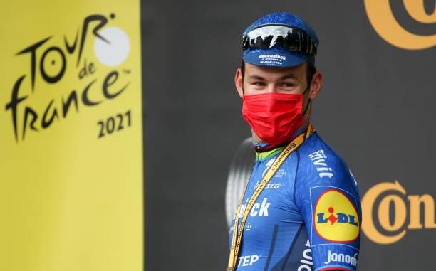 Mark Cavendish of Great Britain and Deceuninck - Quick Step celebrates winning during the podium ceremony stage 4 of the 108th Tour de France 2021, a...