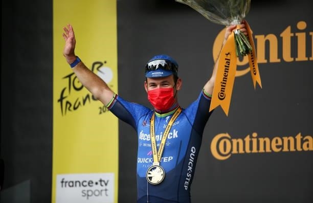 Mark Cavendish of Great Britain and Deceuninck - Quick Step celebrates winning during the podium ceremony stage 4 of the 108th Tour de France 2021, a...