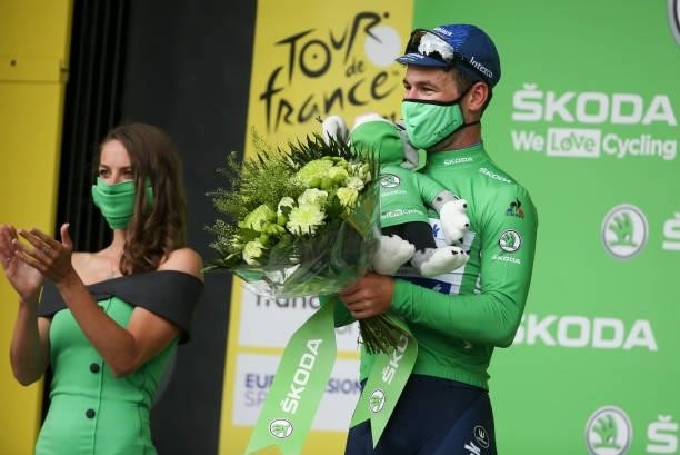 Mark Cavendish of Great Britain and Deceuninck - Quick Step wears the green jersey of best sprinter during the podium ceremony after winning stage 4...