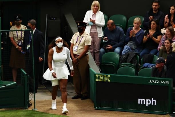 Serena Williams of The United States walks back onto center court after receiving treatment in her Ladies' Singles First Round match against...