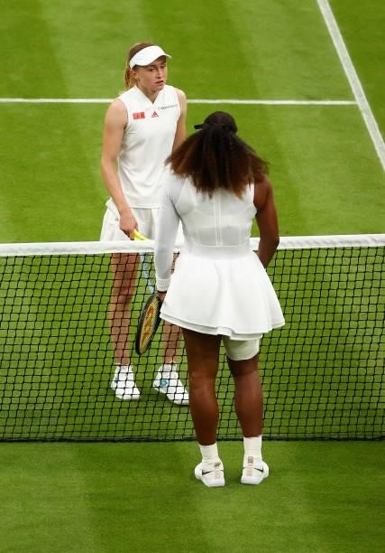 Aliaksandra Sasnovich of Belarus interacts with Serena Williams of The United States at the net after Serena Williams retired from the match with an...