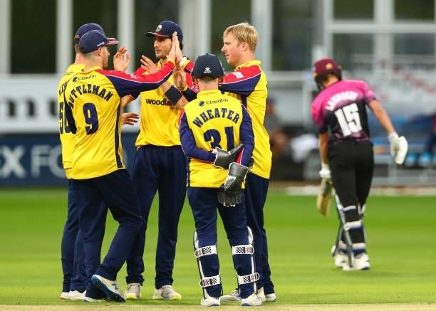 Simon Harmer of Essex Eagles celebrates after bowling out Tom Lammonby of Somerset with Will Buttleman of Essex Eagles and Jimmy Neesham of Essex...