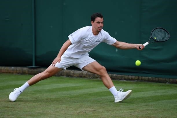 Alex Bolt of Australia stretches to play a forehand in his Men's Singles First Round match against Filip Krajinovic of Serbia during Day Two of The...