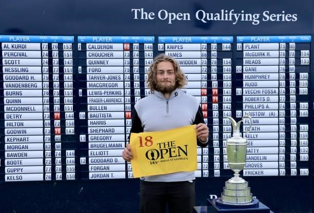 Connor Worsdall of England poses beside the Claret Jug in front of the main scoreboard after securing one of the three qualifying places in the 149th...