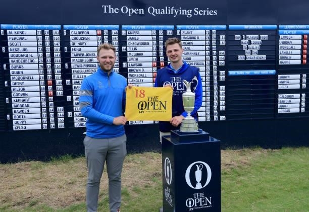 Sam Forgan of England poses with his brother Jack Forgan beside the Claret Jug in front of the main scoreboard after securing one of the three...