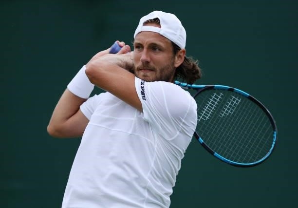 Lucas Pouille of France plays a backhand in his Men's Singles First Round match against Cameron Norrie of Great Britain during Day Two of The...