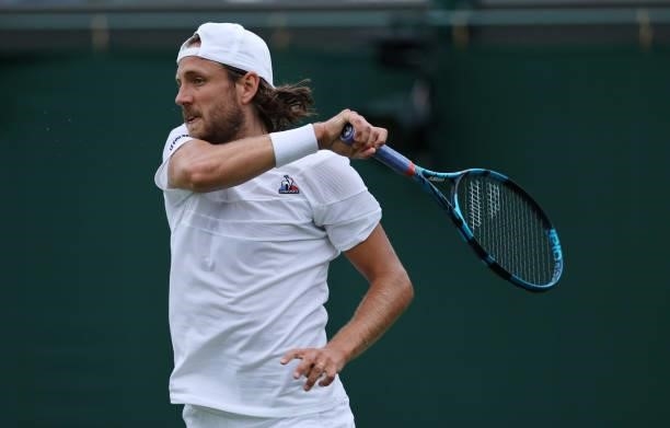 Lucas Pouille of France plays a forehand in his Men's Singles First Round match against Cameron Norrie of Great Britain during Day Two of The...