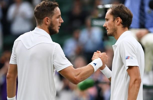 Daniil Medvedev of Russia and Jan-Lennard Struff of Germany shake hands at the net after their Men's Singles First Round match during Day Two of The...