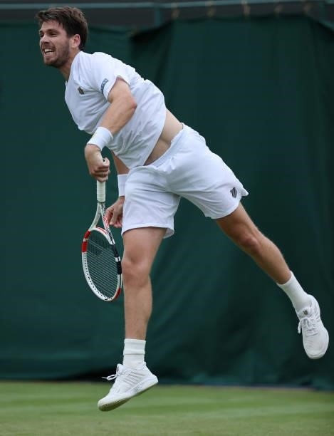 Cameron Norrie of Great Britain serves in his Men's Singles First Round match against Lucas Pouille of France during Day Two of The Championships -...