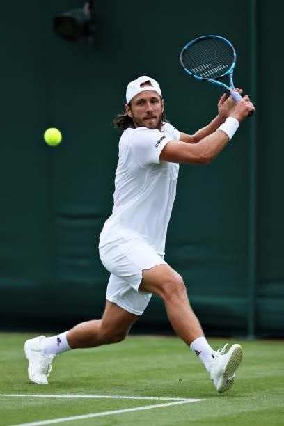 Lucas Pouille of France plays a backhand in his Men's Singles First Round match against Cameron Norrie of Great Britain during Day Two of The...