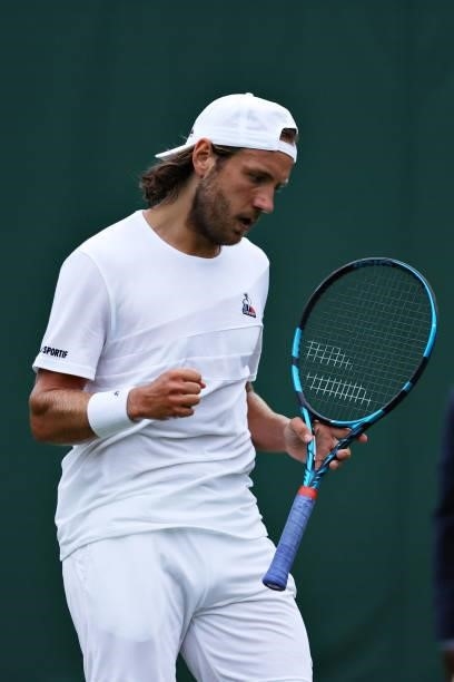 Lucas Pouille of France celebrates in his Men's Singles First Round match against Cameron Norrie of Great Britain during Day Two of The Championships...