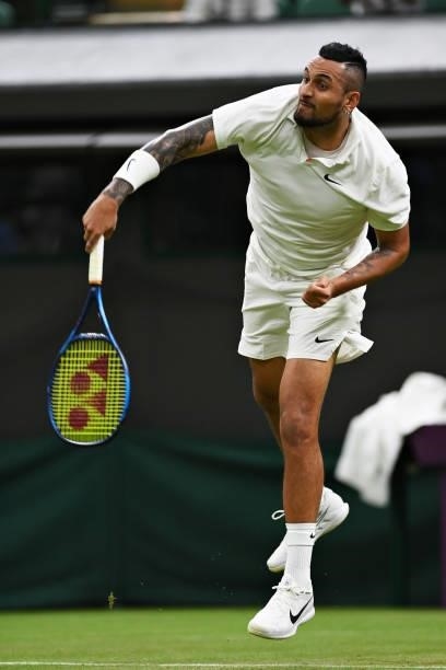 Nick Kyrgios of Australia serves in his Men's Singles First Round match against Ugo Humbert of France during Day Two of The Championships - Wimbledon...
