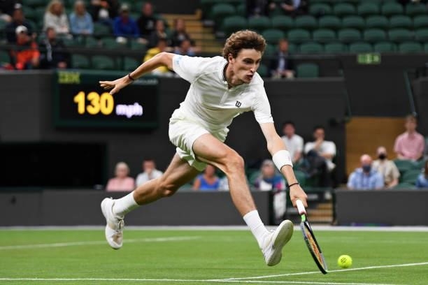 Ugo Humbert of France stretches to play a backhand in his Men's Singles First Round match against Nick Kyrgios of Australia during Day Two of The...
