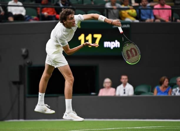 Ugo Humbert of France serves in his Men's Singles First Round match against Nick Kyrgios of Australia during Day Two of The Championships - Wimbledon...