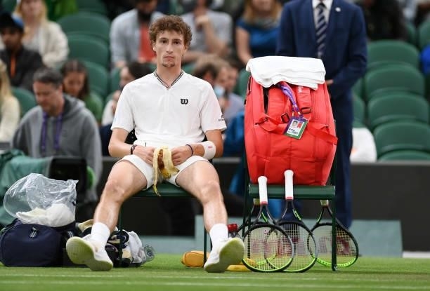 Ugo Humbert of France looks on as he sits down during a change of ends in his Men's Singles First Round match against Nick Kyrgios of Australia...