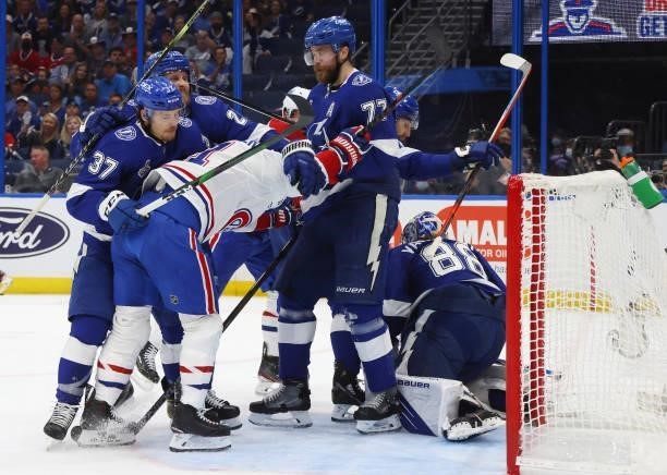 Brendan Gallagher of the Montreal Canadiens is held up by the Tampa Bay Lightning during Game One of the 2021 NHL Stanley Cup Finals against the...