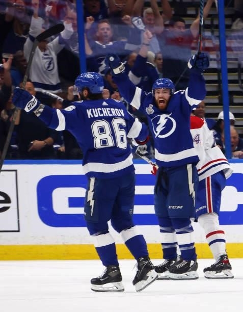 Nikita Kucherov of the Tampa Bay Lightning is congratulated by Brayden Point after scoring a goal against the Montreal Canadiens during the third...
