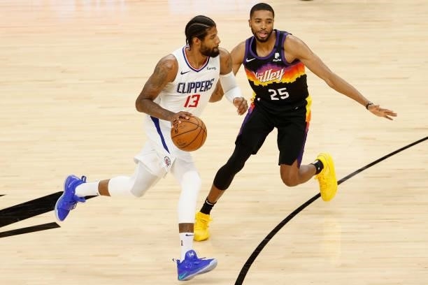 Paul George of the LA Clippers handles the ball against Mikal Bridges of the Phoenix Suns during the second half of game five of the Western...