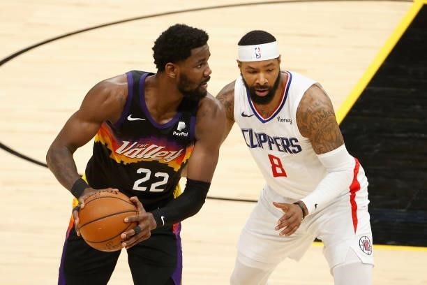 Deandre Ayton of the Phoenix Suns looks to pass around Marcus Morris Sr. #8 of the LA Clippers during the first half of game five of the Western...