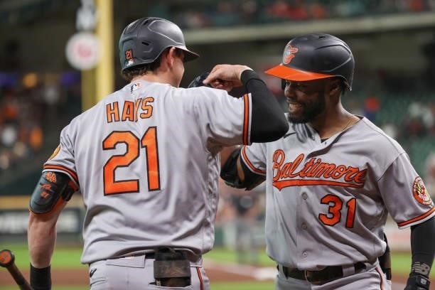 Cedric Mullins of the Baltimore Orioles high fives Austin Hays after hitting a home run during the first inning against the Houston Astros at Minute...